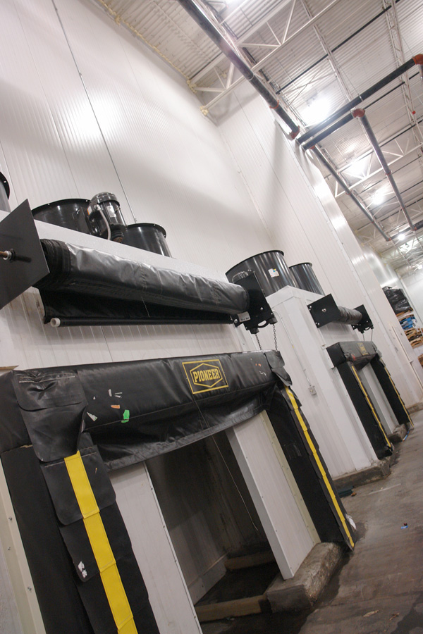 Insulated dock seals and levelers along the refrigerated loading dock
