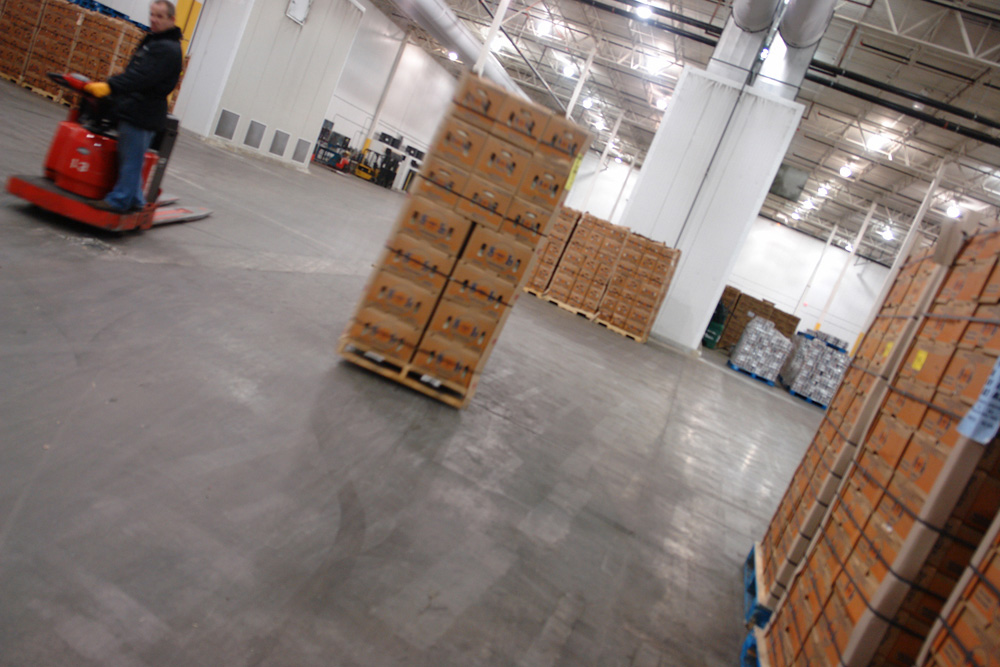 An operator crossing the cooler floor on an electric pallet jack